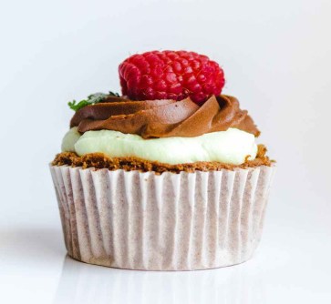 photograph of chocolate cupcake with red strawberry toppings