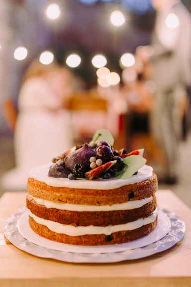 shallow focus of white icing covered cake on white ceramic plate